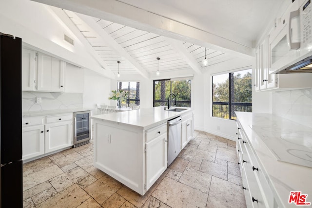 kitchen with tasteful backsplash, white appliances, beamed ceiling, and white cabinetry