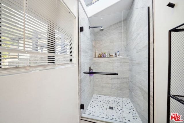 bathroom featuring a shower with door