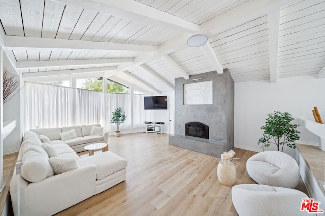 living room with vaulted ceiling with beams, light wood-type flooring, a fireplace, and wooden ceiling