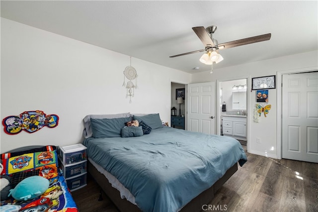 bedroom with dark hardwood / wood-style floors, ensuite bathroom, and ceiling fan