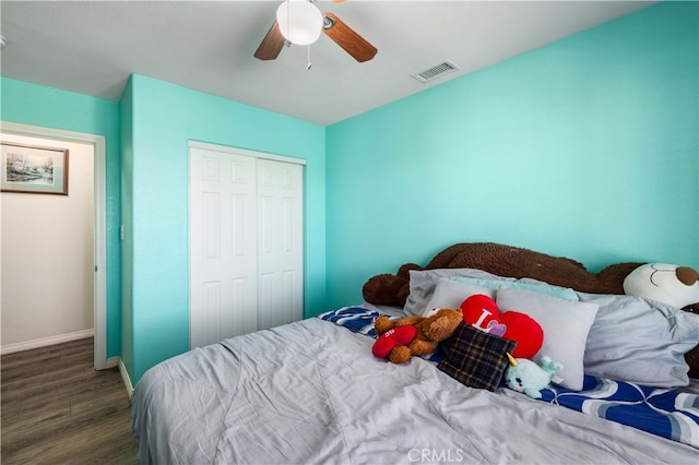 bedroom featuring dark hardwood / wood-style floors, a closet, and ceiling fan