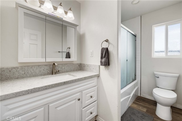 full bathroom with toilet, enclosed tub / shower combo, vanity, and wood-type flooring