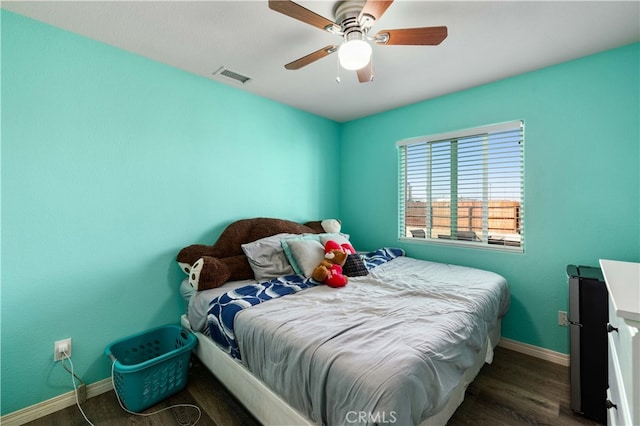 bedroom featuring dark hardwood / wood-style flooring and ceiling fan