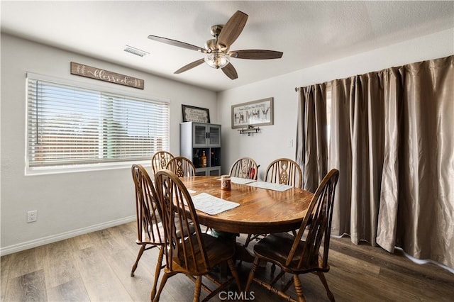 dining area featuring ceiling fan and hardwood / wood-style flooring