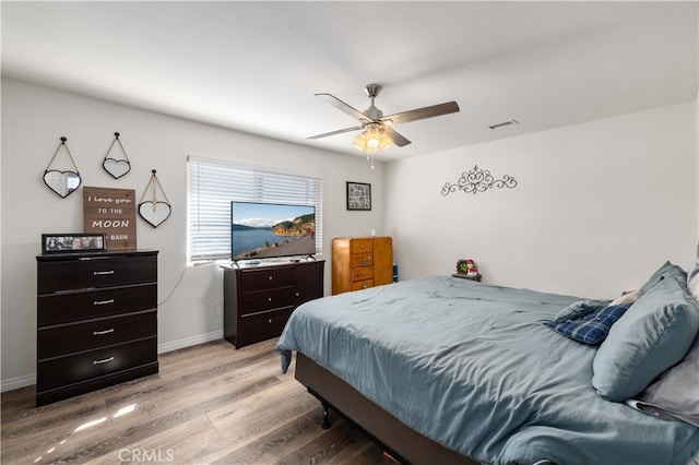 bedroom with wood-type flooring and ceiling fan