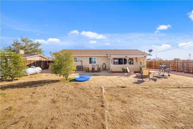 rear view of property featuring a patio