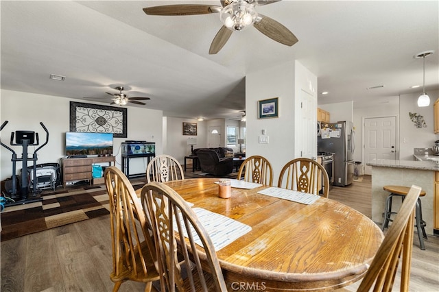 dining space featuring ceiling fan and hardwood / wood-style flooring