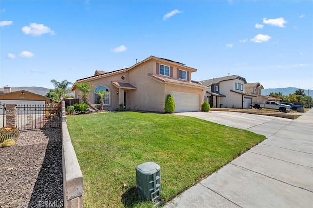 view of front of property featuring a front yard, a mountain view, and a garage