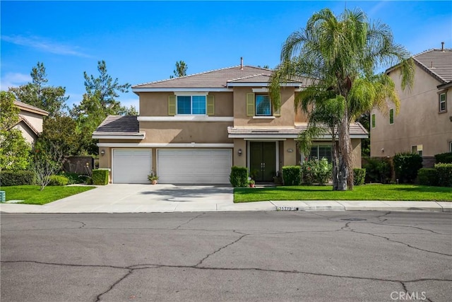 traditional-style house with stucco siding, a front lawn, driveway, and a garage