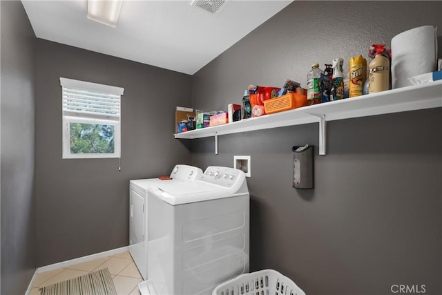 laundry area with light tile patterned floors, laundry area, baseboards, visible vents, and independent washer and dryer