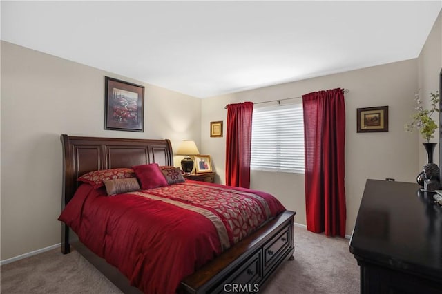 bedroom featuring light carpet and baseboards