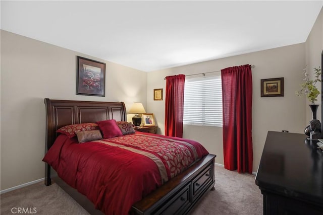 carpeted bedroom featuring baseboards