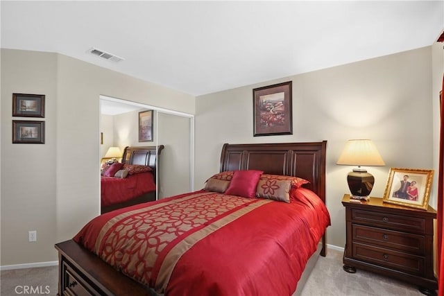 bedroom featuring light colored carpet, visible vents, and baseboards