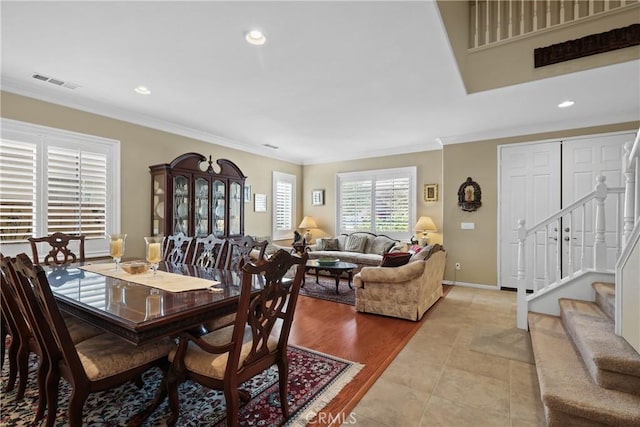 dining space with light tile patterned floors, recessed lighting, visible vents, stairs, and ornamental molding