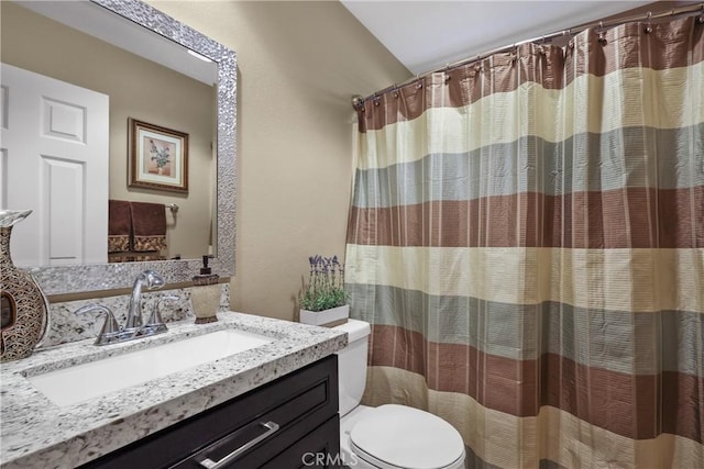 full bath featuring toilet, curtained shower, and vanity