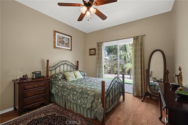 bedroom featuring baseboards, light wood finished floors, a ceiling fan, and access to exterior