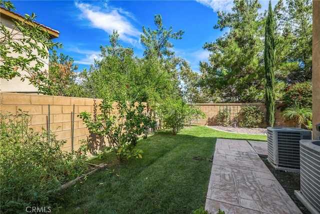 view of yard featuring a patio area, a fenced backyard, and cooling unit
