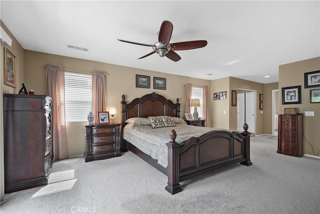 bedroom featuring visible vents, ceiling fan, and light carpet