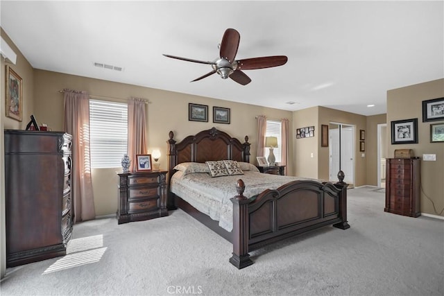 bedroom featuring visible vents, light colored carpet, and ceiling fan