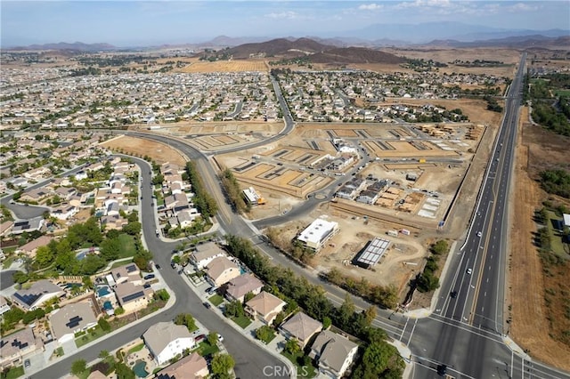 drone / aerial view featuring a residential view and a mountain view