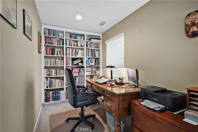 office area featuring light carpet, visible vents, and baseboards