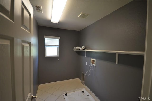 laundry room featuring tile patterned floors, visible vents, laundry area, and washer hookup