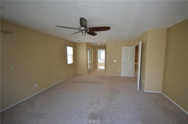 empty room with baseboards, carpet flooring, and ceiling fan