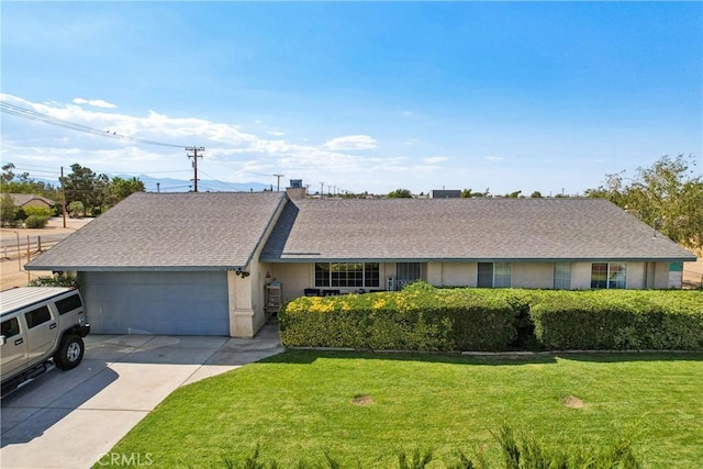 single story home featuring a front yard and a garage