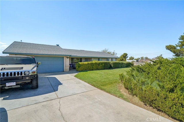 single story home with a garage and a front lawn