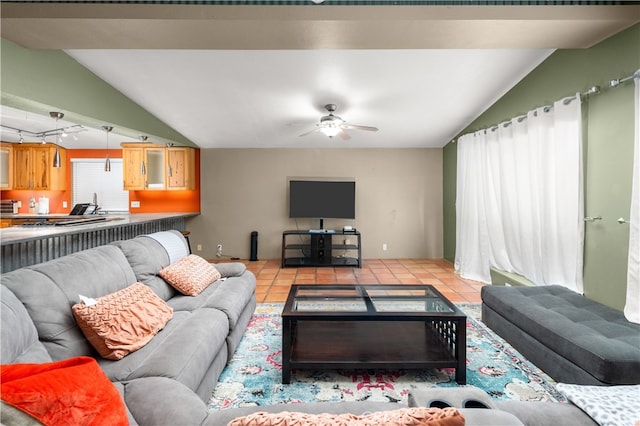 living room featuring ceiling fan, plenty of natural light, and vaulted ceiling