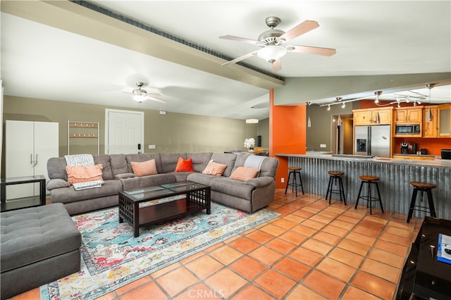 tiled living room featuring vaulted ceiling and ceiling fan