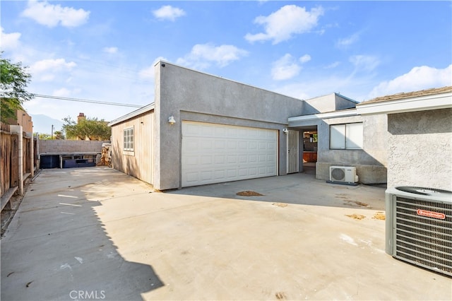 exterior space featuring cooling unit and a garage