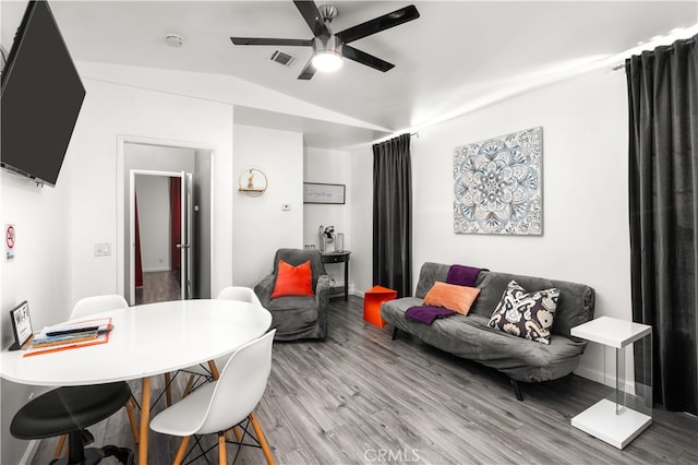 interior space with hardwood / wood-style floors, ceiling fan, and vaulted ceiling