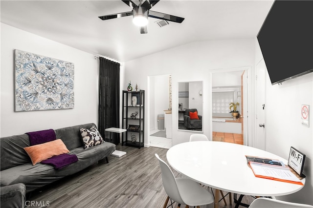 dining space featuring lofted ceiling, hardwood / wood-style floors, and ceiling fan