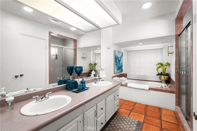 bathroom featuring vanity, tile patterned flooring, and plus walk in shower