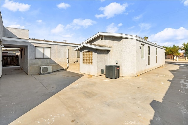 view of property exterior with a patio and central air condition unit