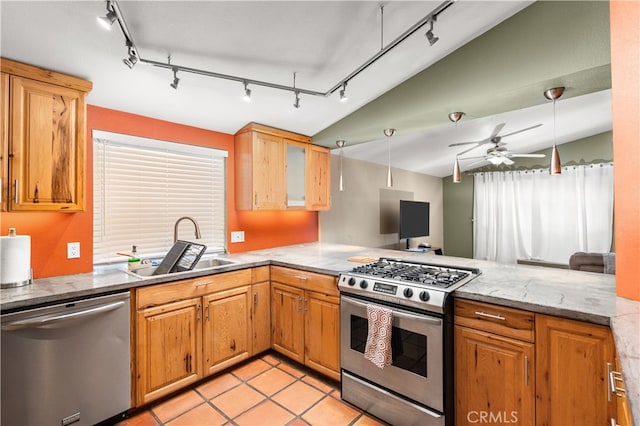 kitchen with appliances with stainless steel finishes, ceiling fan, sink, and vaulted ceiling