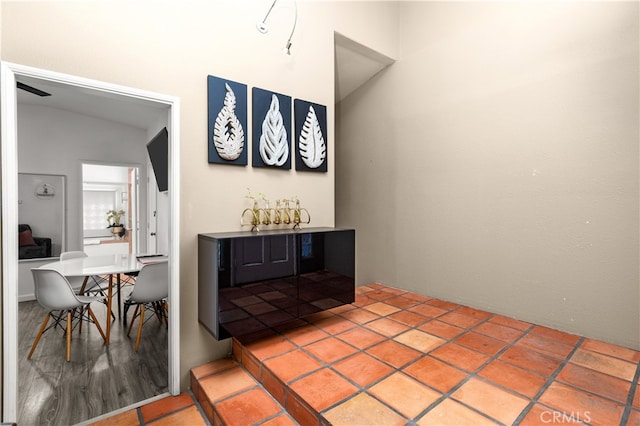 hallway with vaulted ceiling and hardwood / wood-style flooring