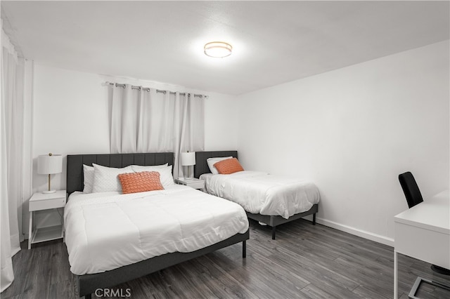 bedroom with dark hardwood / wood-style flooring