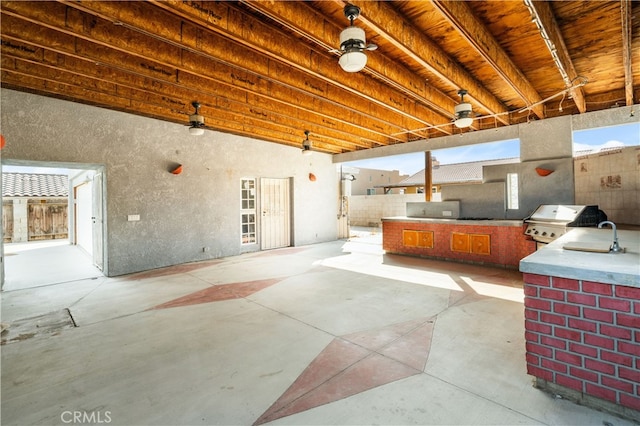 view of patio / terrace featuring exterior kitchen and a grill