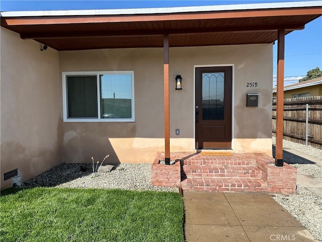 view of exterior entry featuring a porch