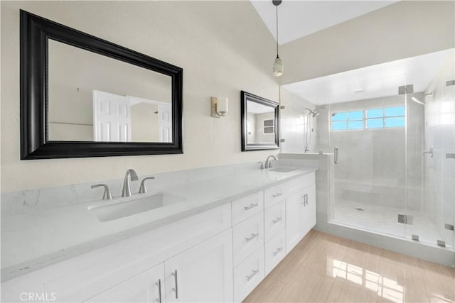 bathroom featuring vanity, lofted ceiling, and walk in shower