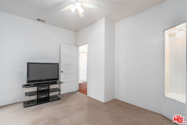 interior space with ceiling fan and carpet floors