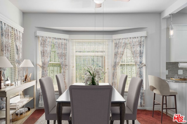 carpeted dining room featuring ceiling fan