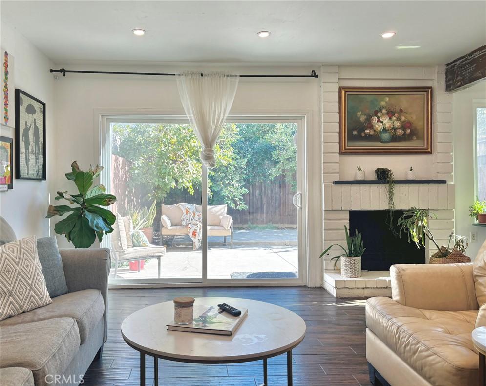 living room with dark hardwood / wood-style floors and a wealth of natural light