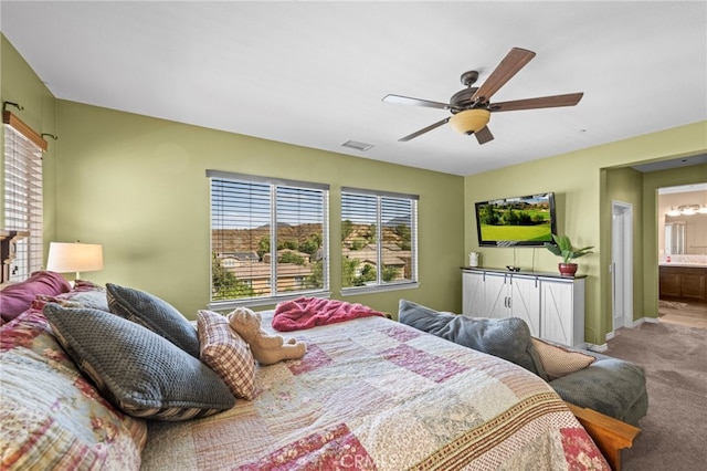 carpeted bedroom featuring ensuite bathroom and ceiling fan