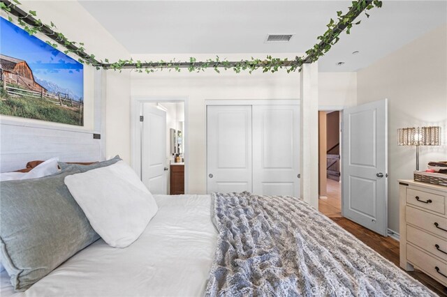 bedroom featuring hardwood / wood-style floors, a closet, and connected bathroom