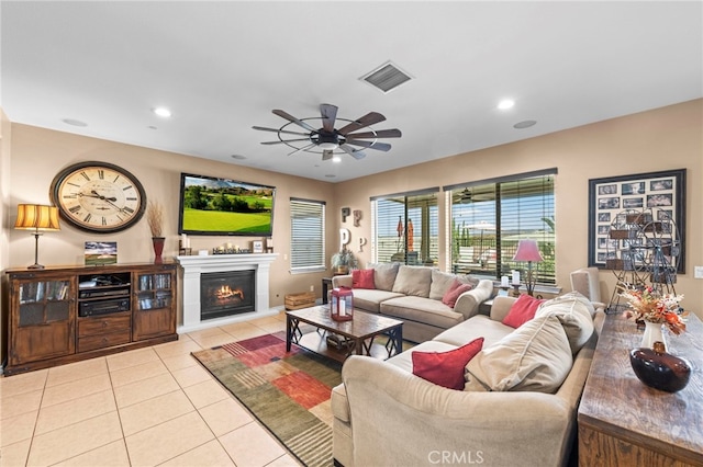 tiled living room featuring ceiling fan