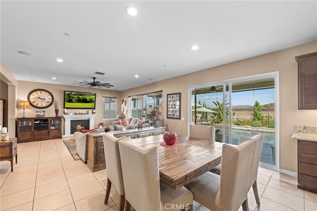 tiled dining space with ceiling fan