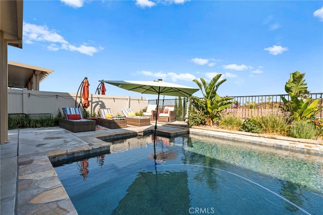 view of swimming pool featuring an outdoor living space and a patio area